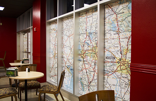 Vintage Texas roadmaps were enlarged and used to block off windows to an exterior room.